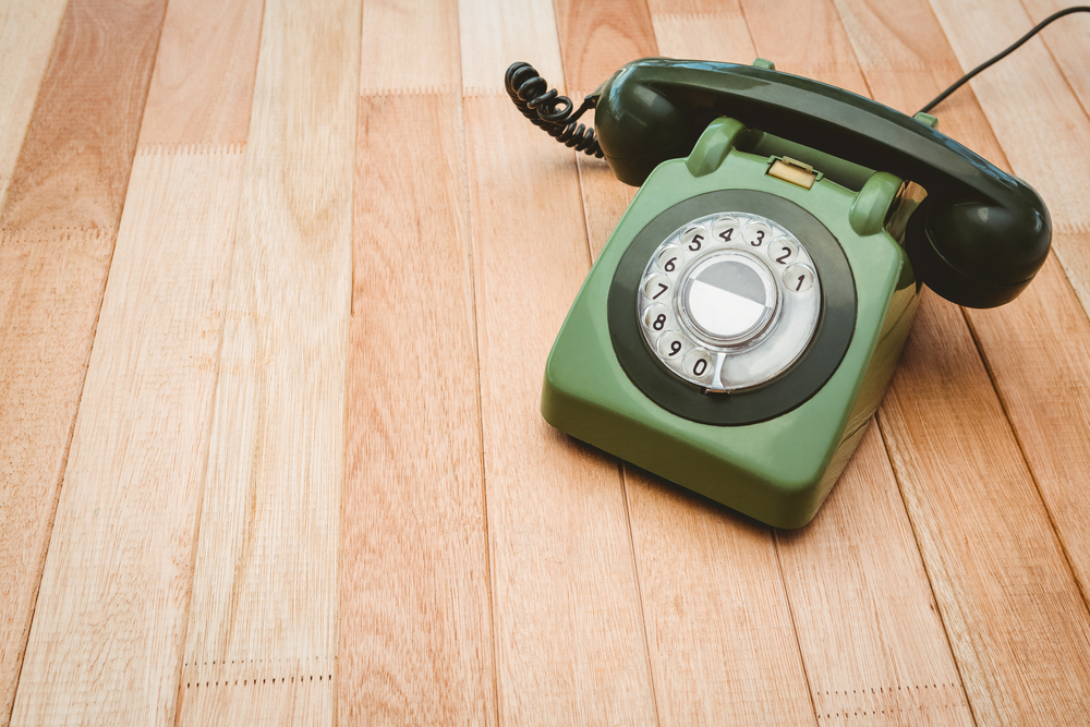 View of an old phone on wood desk